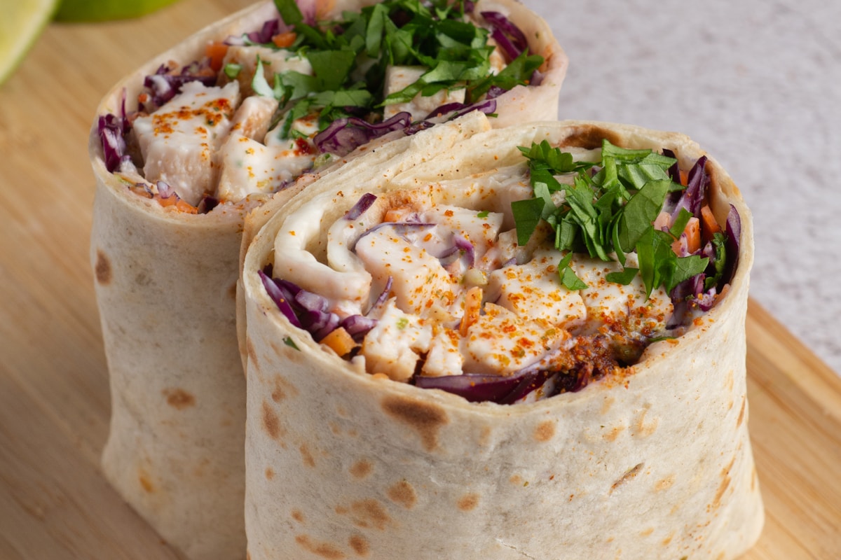 Mediterranean wrap filled with hummus and fresh vegetables